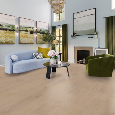 blue couch and green chair with green drapes and woodlook flooring