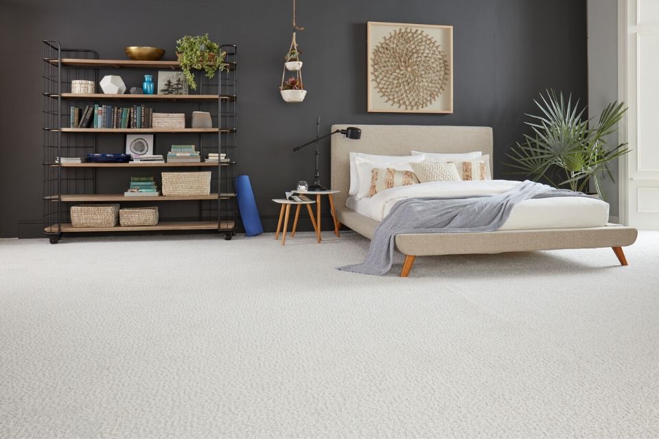 Beige living room carpet in bedroom with dark gray walls 