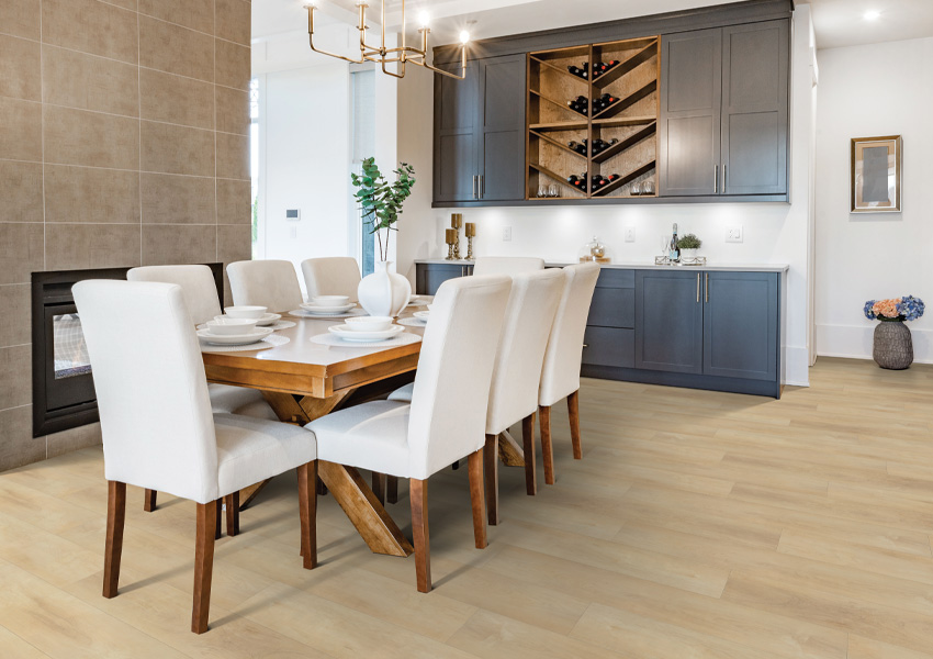 laminate flooring in dining room with wood table and white fabric chairs.